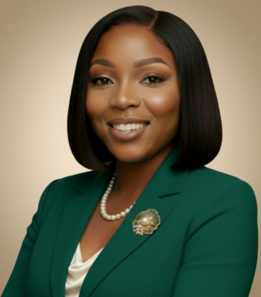 Ifeoluwa Johnson professional headshot smiling wearing a dark green blazer with string of pearls and a matching lapel brooch.