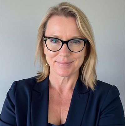 Melissa Walters Corfield professional headshot in a dark blazer and black rimmed glasses