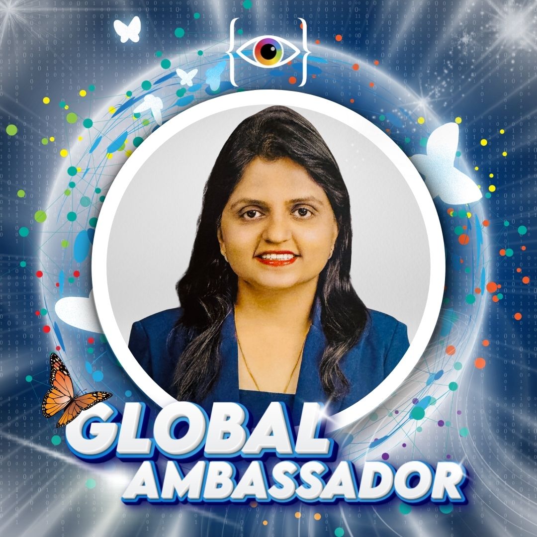 Mrunal Gangrade Professional Head-and-shoulders portrait of a woman in a blue blazer, smiling softly at the camera, dark hair framing her face inside of the Global Ambassador badge with those words, the I AM WHO I SAY I AM monarch butterfly with a globe and red, white, green and blue circles swirling around and the I AM WHO I SAY I AM logo bug with coding brackets and the rainbow eye in-between