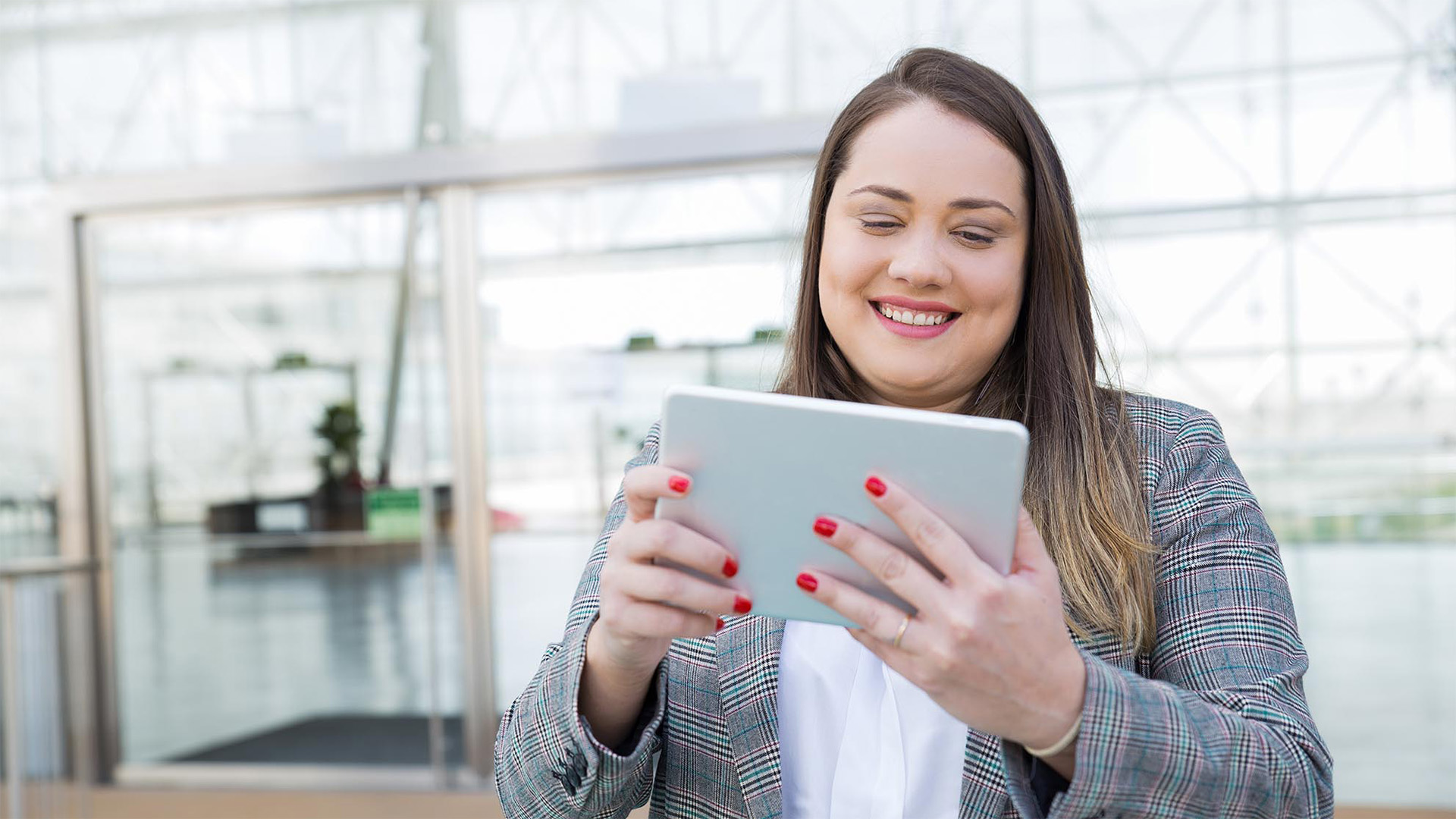 woman data scientist on her ipad smiling working the proprietary Identity Trajectory Intelligence™ assessment.